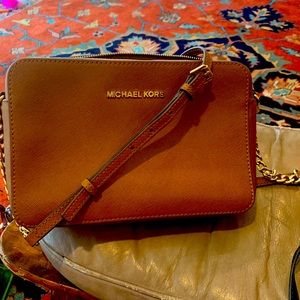 Michael Kors mini bag. Cognac color with gold chain trim. Cross body strap